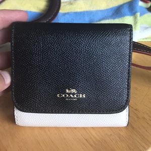 Black and cream Coach wallet